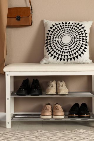 Boot room with a shoe rack and cushion