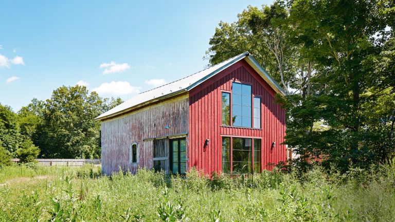exterior of distressed and red painted carriage house