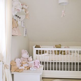 attic nursery with cot bed and toys
