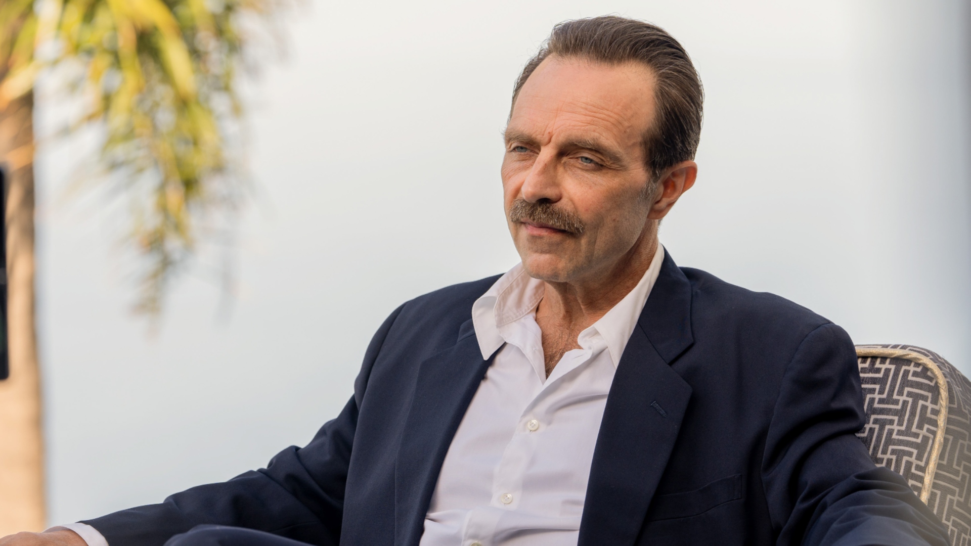 Ivan sits in a chair in The Gold season 2
