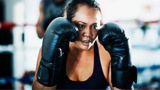 Woman holding up boxing gloves