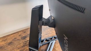 Close up of Lenovo Legion R27fc-30 stand showing it can go up and down, be tilted up and down, or pivoted to the sides.