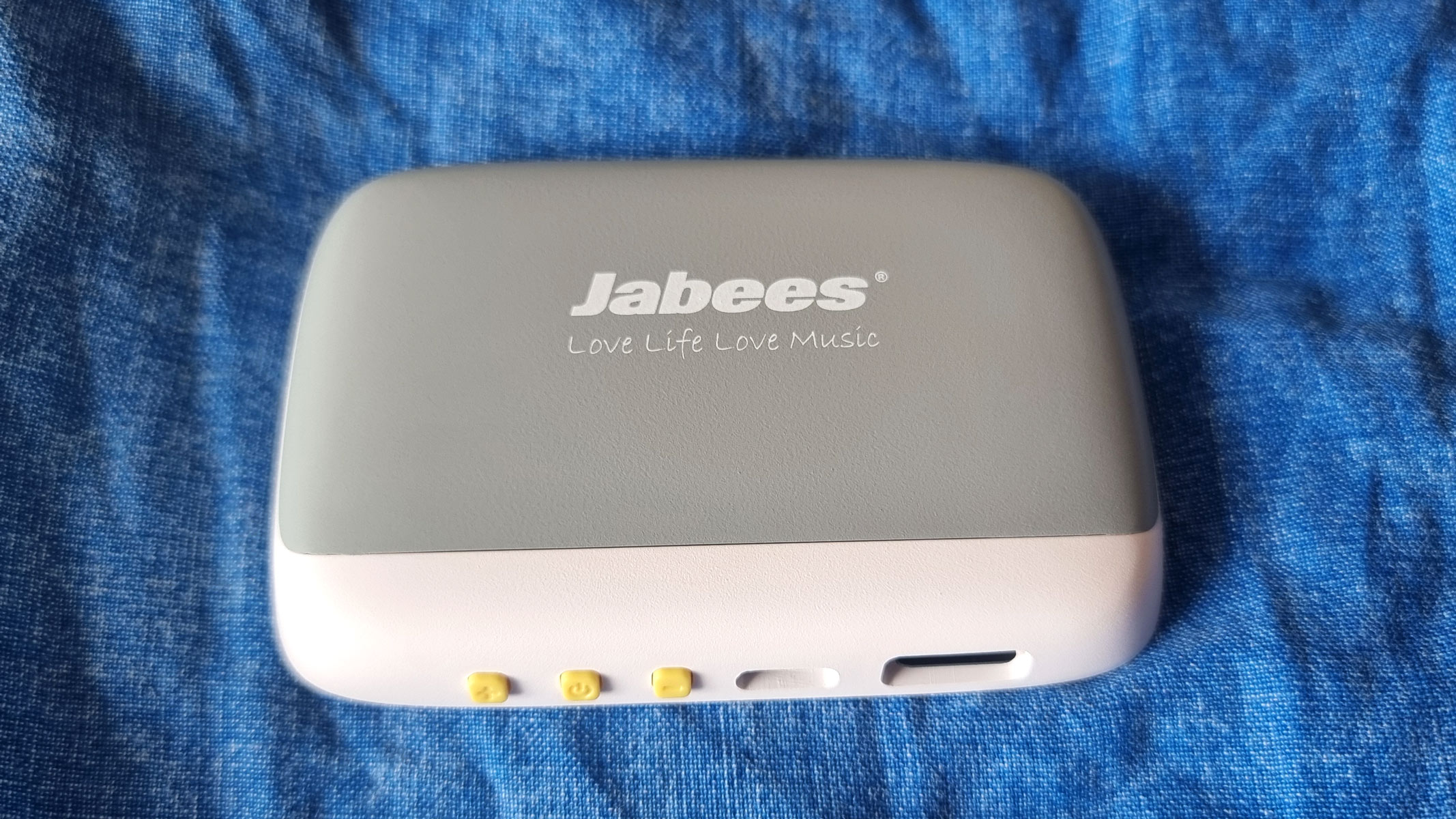 Jabees Peace Pillow Speaker on a blue pillow