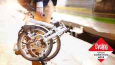 Male cyclist holding a folding bike