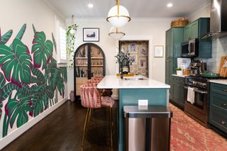 Kitchen with hand painted mural on the wall and green cabinets