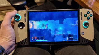 The MSI Claw 8 AI+ held in the hand, playing Dead Cells on the 8-inch screen.