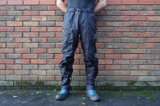 Image shows a rider wearing the Showers Pass Transit Pants.
