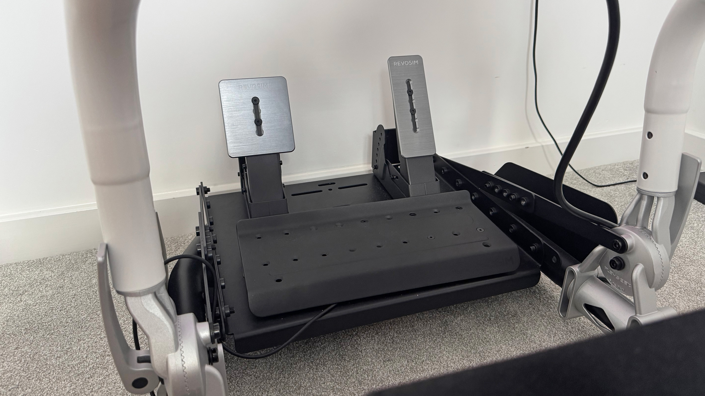 The Nacon Revosim RS Pure bundle&#039;s pedals mounted to a PlaySeat chair