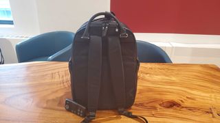black laptop backpack sitting on a wooden table