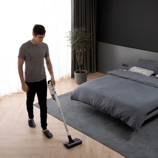 Man cleaning bedroom wood flooring with the Roidmi RS60 mop