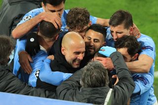 Manchester City players celebrate with manager Pep Guardiola after a Phil Foden goal against Borussia Dortmund in the Champions League in 2021.