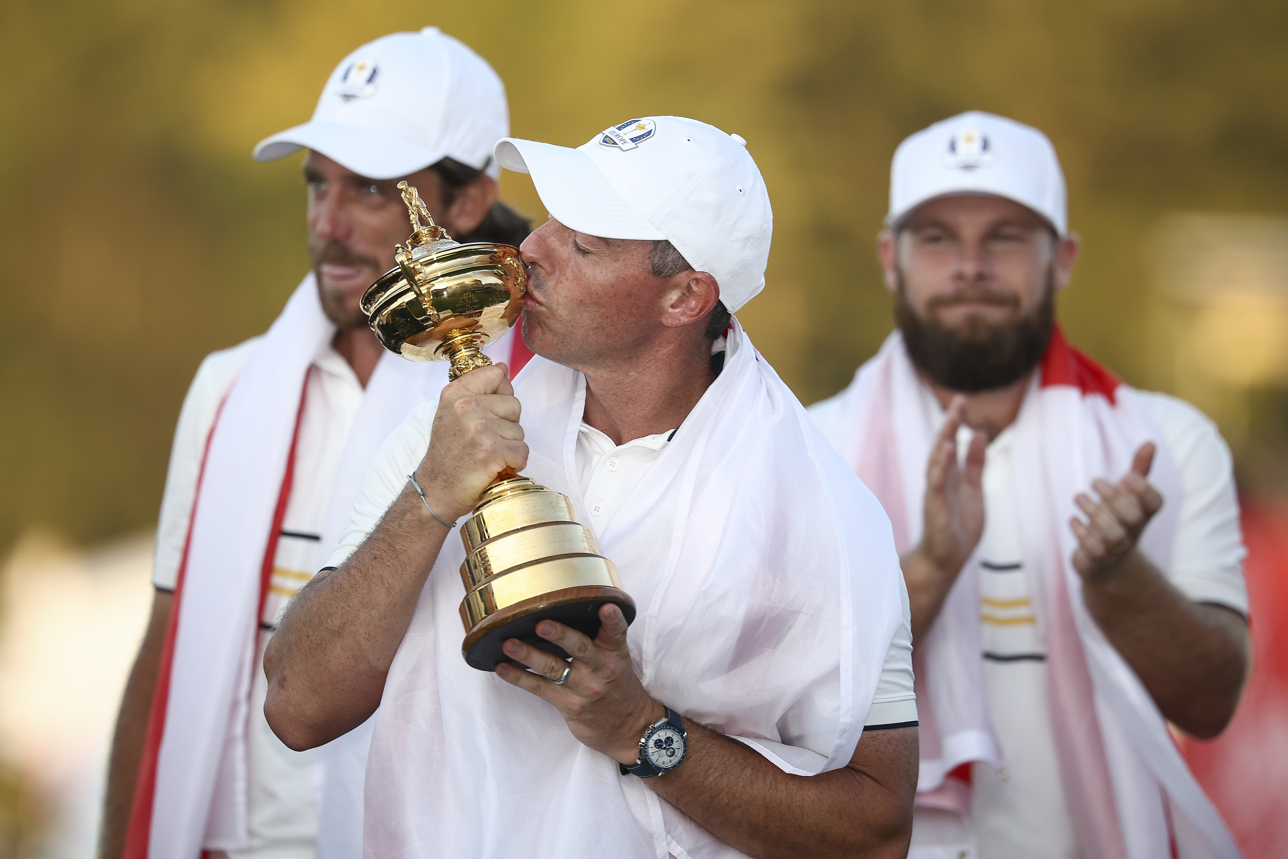 Rory McIlroy holds and kisses the Ryder Cup trophy