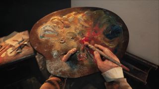 A painter wipes a brush across a palette