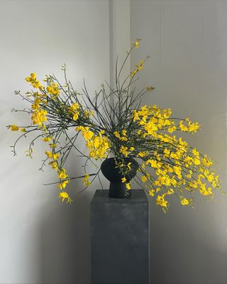 a fresh flower arrangement on a gray pedestal