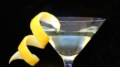 A martini with a big lemon peel twist.