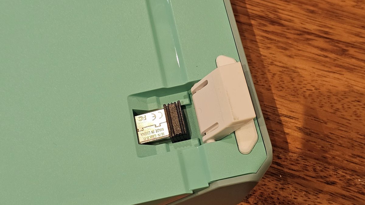 back of Cooler Master MK770 showing dongle storage under flip-up feet