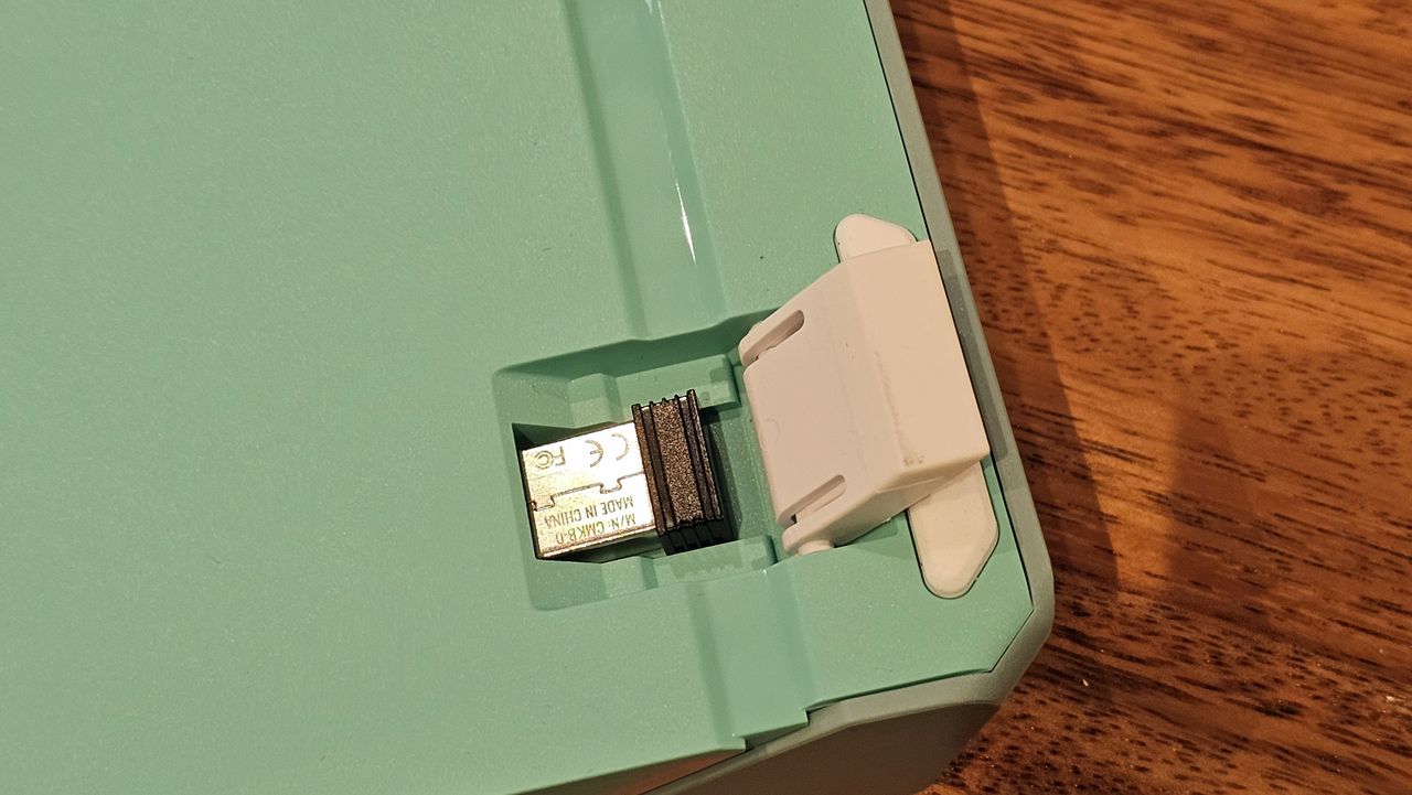 back of Cooler Master MK770 showing dongle storage under flip-up feet