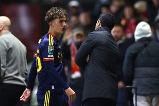 Mikel Arteta, Manager of Arsenal, talks to Max Dowman of Arsenal as he walks off the pitch after being sent off during the Carabao Cup Fourth Round
