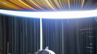 A series of white streaks against a dark background show the star trails in orbit