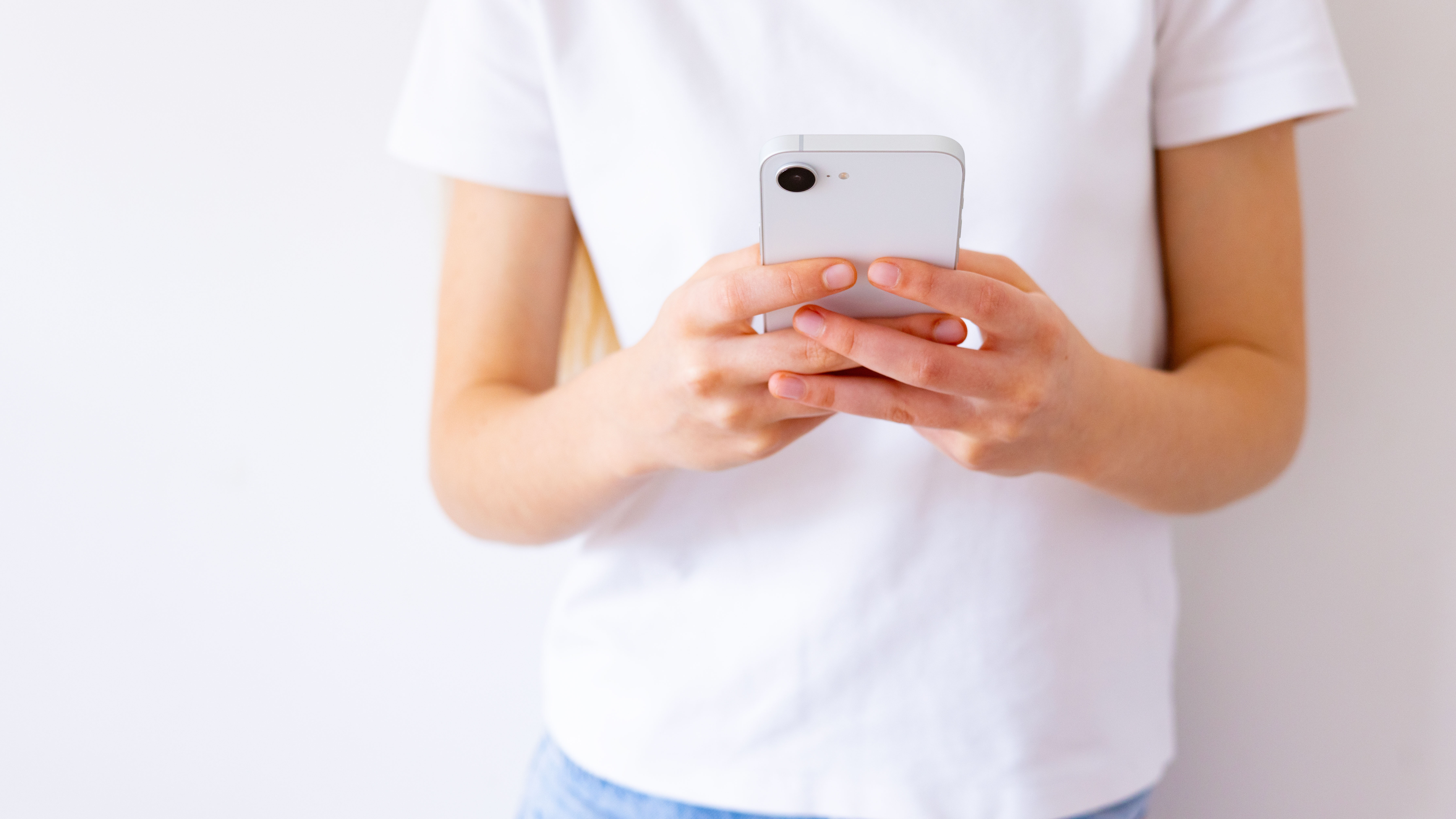 Girl typing something on mobile phone