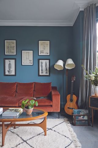 hague blue living room with rust sofa and Berber rug
