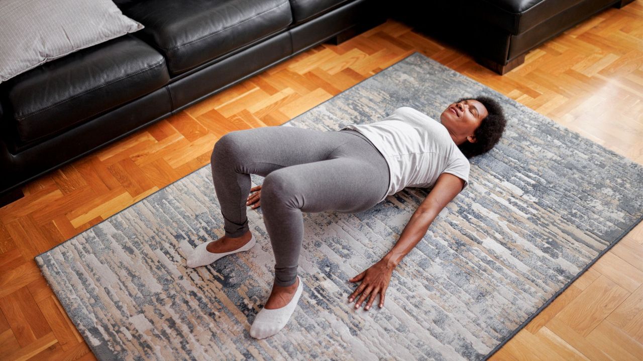 Woman doing a glute bridge on the floor