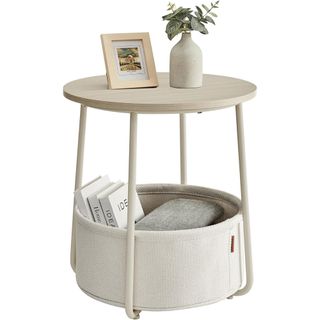 small cream circular side table with storage basket beneath