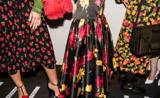 A close-up of heavy silk skirts and floral-print dresses
