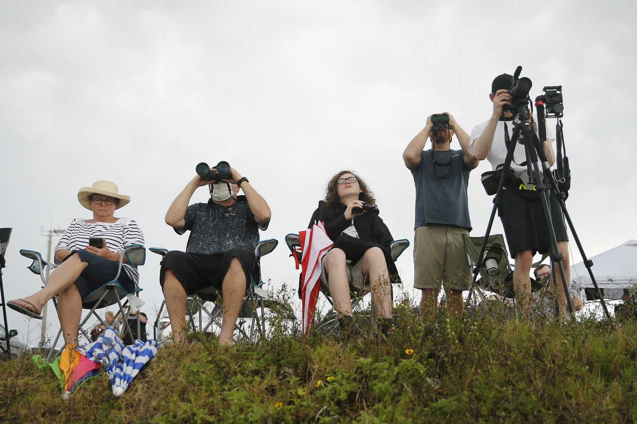 One mask is visible in this photo of people gathered to watch SpaceX's launch attempt May 27, 2020.