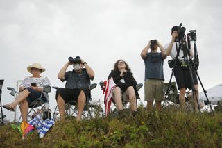 One mask is visible in this photo of people gathered to watch SpaceX's launch attempt May 27, 2020.