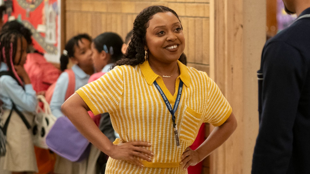 Quinta Brunson smiling and putting her hands on her hips in Abbott Elementary.