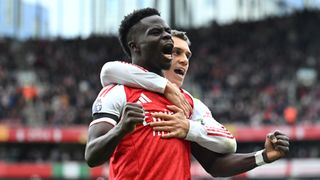 Bukayo Saka of Arsenal celebrates scoring his team's second goal from the penalty spot with teammate Leandro Trossard during the Premier League match between Arsenal and West Ham United at Emirates Stadium on October 04, 2025 in London, England. 