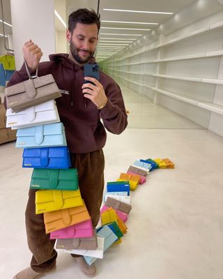 Simon Jacquemus holding colorful bags