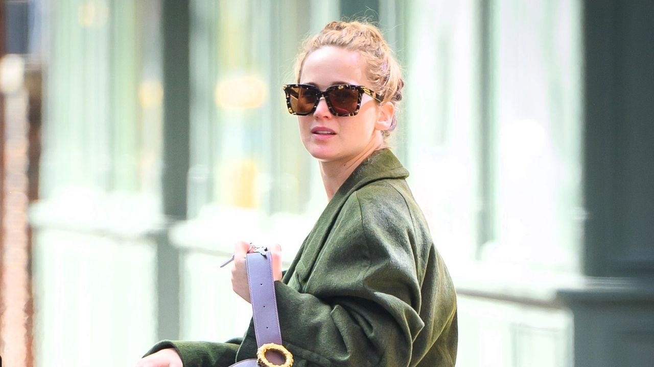 Jennifer Lawrence walks in New York City wearing a green coat