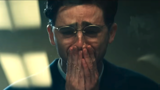 Timothee Chalamet crying with his hands on his mouth as Marty Mouser at the end of Marty Supreme 