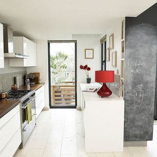 white kitchen in victorian terrace in bristol with chalk painted wall