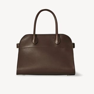 Flat lay image of brown leather handbag