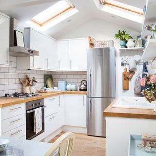 White kitchen with skylights and wooden worktops