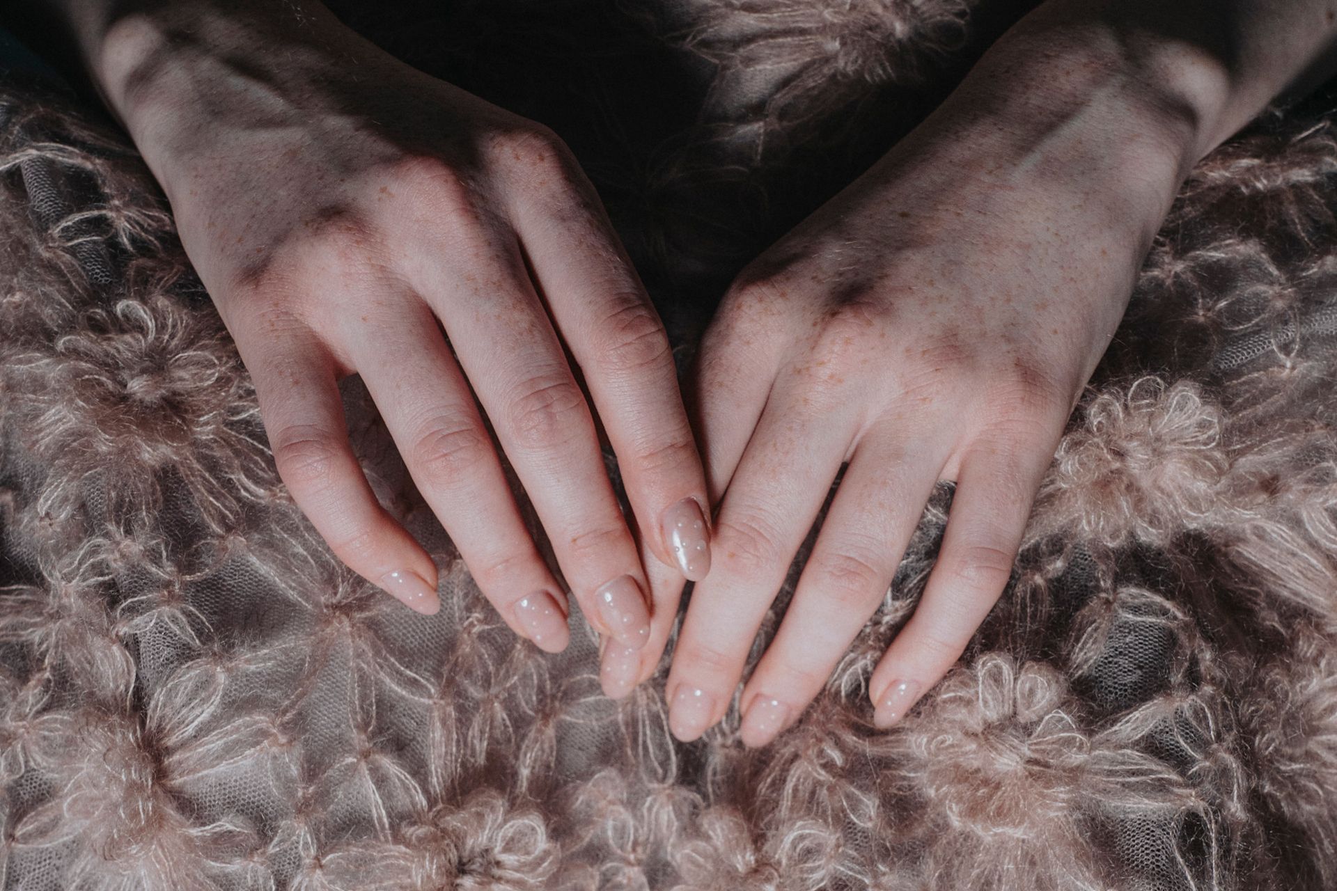 Various women with neutral colored manicures. 