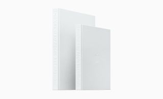 Exterior view of the white 'Designed by Apple in California' book in two sizes pictured against a white background