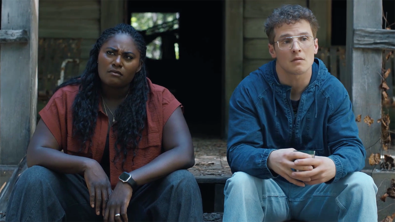 Leota and Adrian sitting on the porch of a wooden hut in Peacemaker season 2