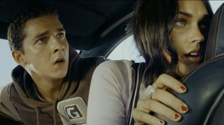 Megan Fox's Mikaela Banes and Shia LaBeouf's Sam Witwicky, inside Bumblebee and on the run in Transformers (2007) .