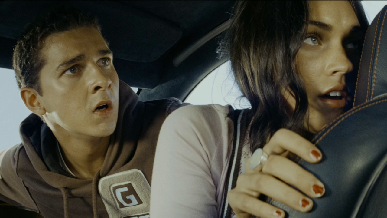 Megan Fox's Mikaela Banes and Shia LaBeouf's Sam Witwicky, inside Bumblebee and on the run in Transformers (2007) .