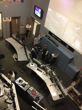 Workers perform maintenance on a mission control room at the CSA normally used during robotics work on the International Space Station.