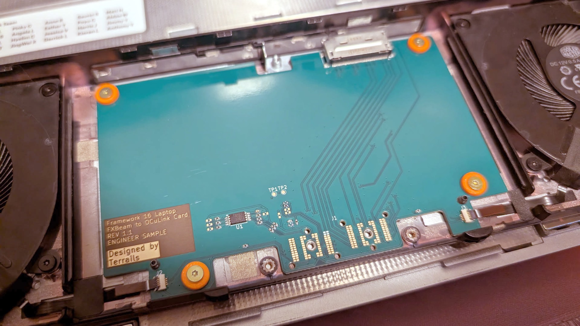 A photo of an adapter board adding OCuLink connections to a Framework Laptop 16.
