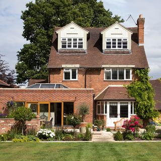 building brick walls white door windows and garden