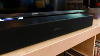 Sonos Beam speaker in front of a TV