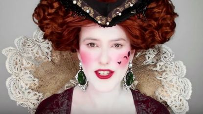 A woman wearing historical makeup.