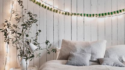 Christmas Bedroom with Chalk Paint walls with fairy lights above a bed - Annie Sloan 