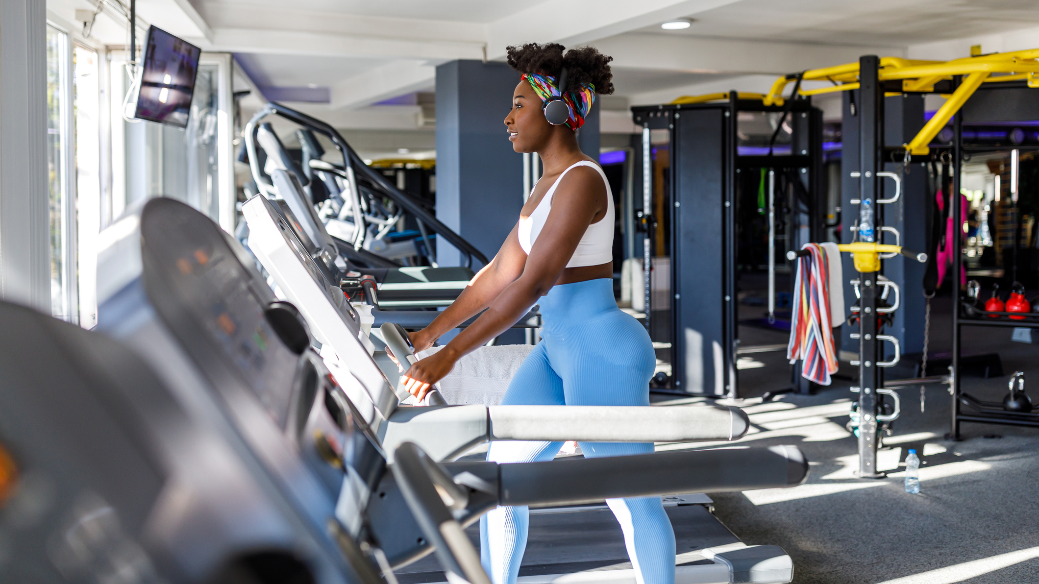 Woman walks on treadmill in the gym
